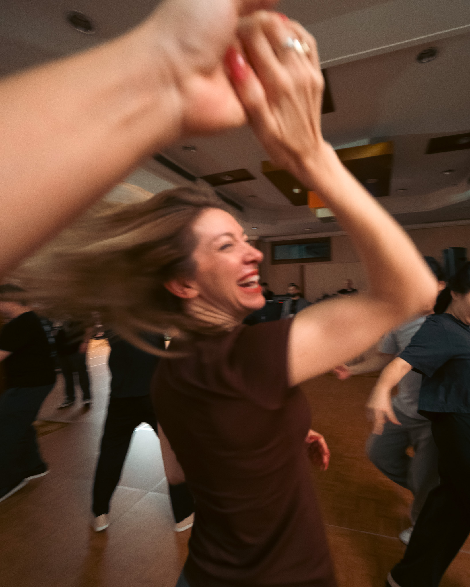 A dancer laughs through a turn on the social floor.