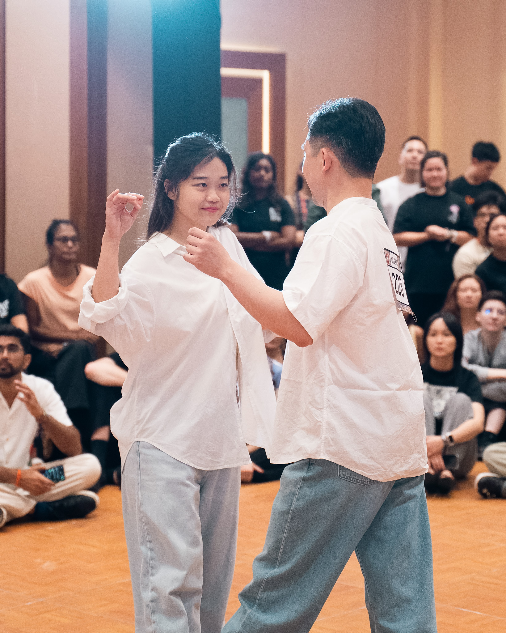 A pair smiles at one another during a competition dance.