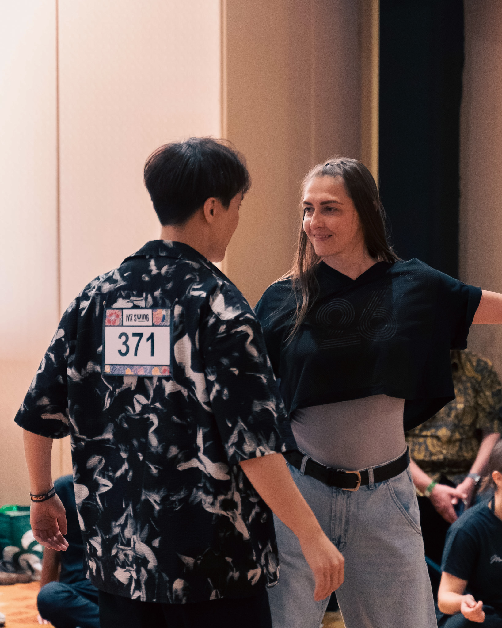 Competitors face each other during a playful moment on the floor.