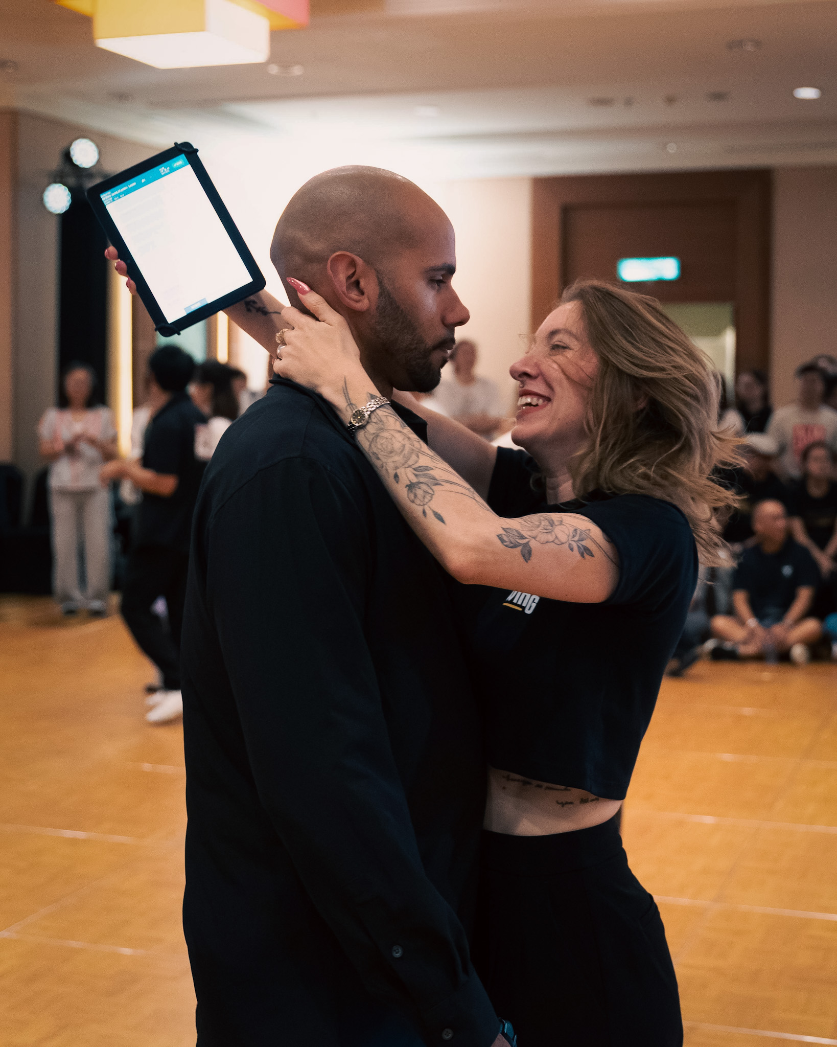 A couple smiles together between movements.