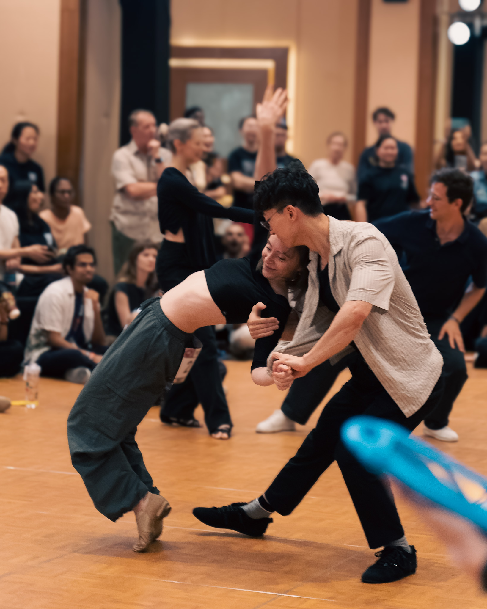 Partners lean away from each other in an expressive move.