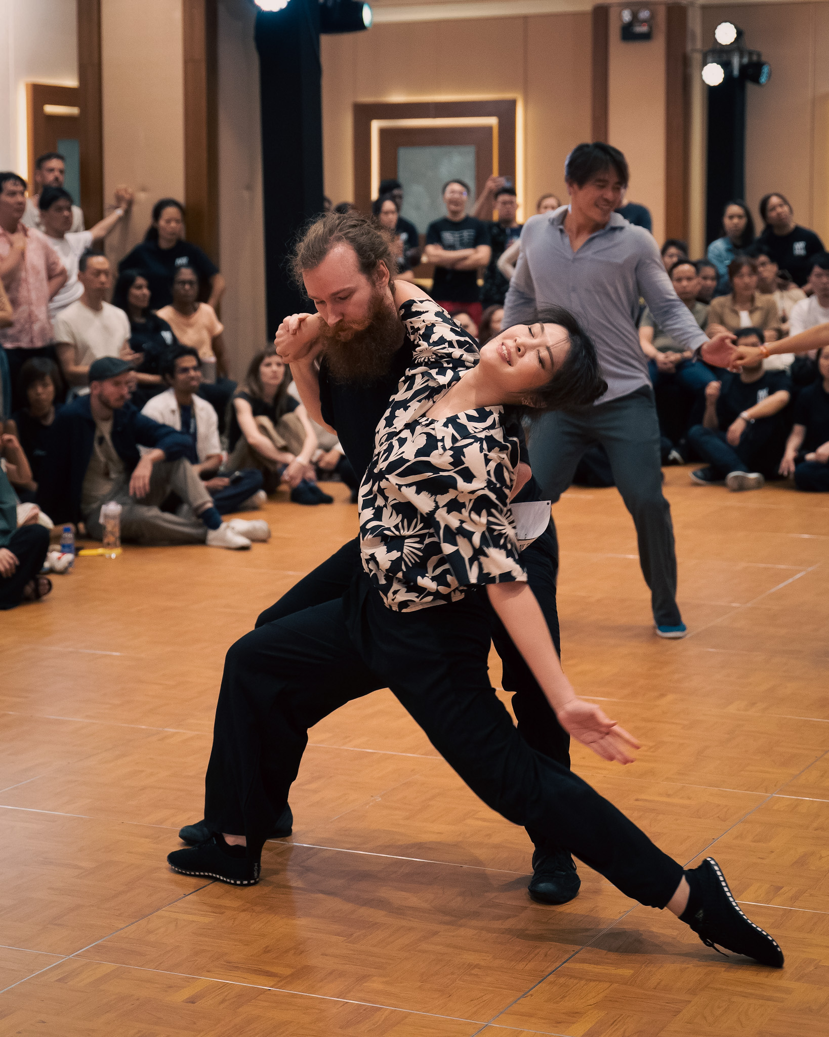 A couple extends into a dramatic lunge on the dance floor.