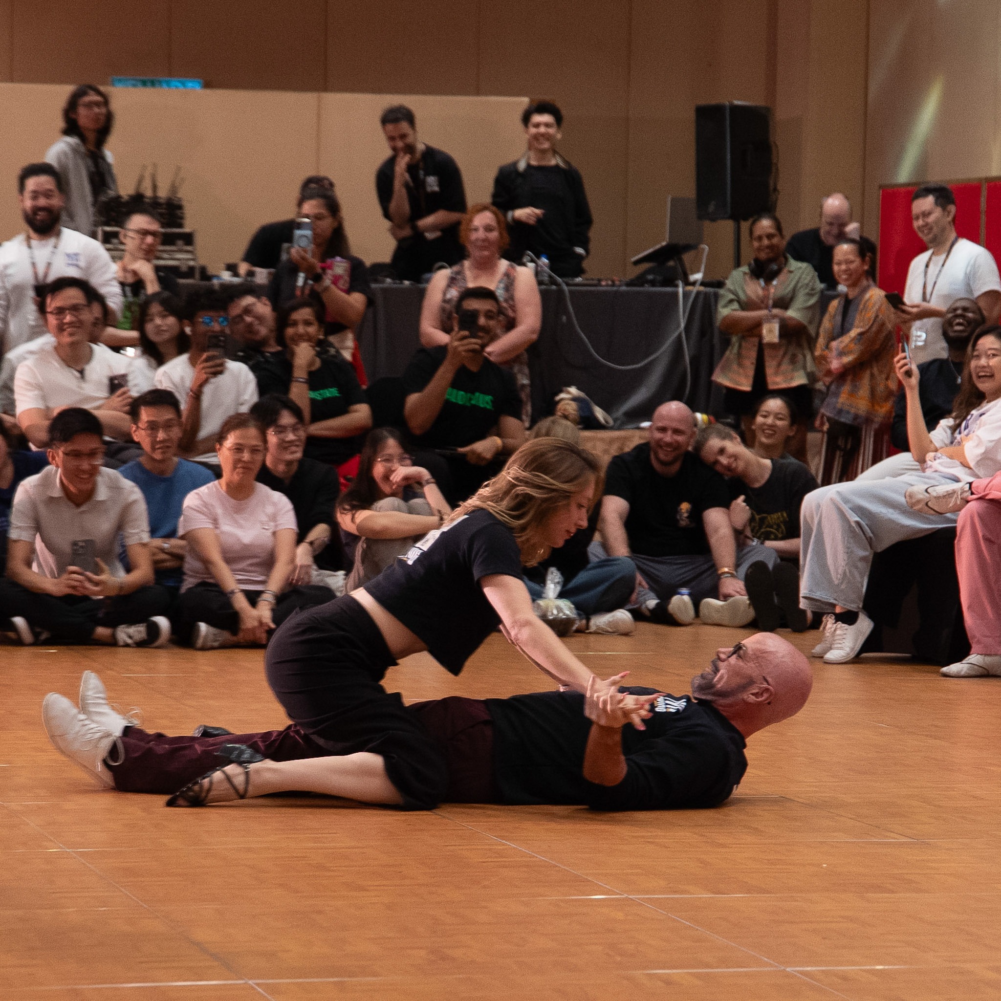 Two performers extend into a low floor sequence.