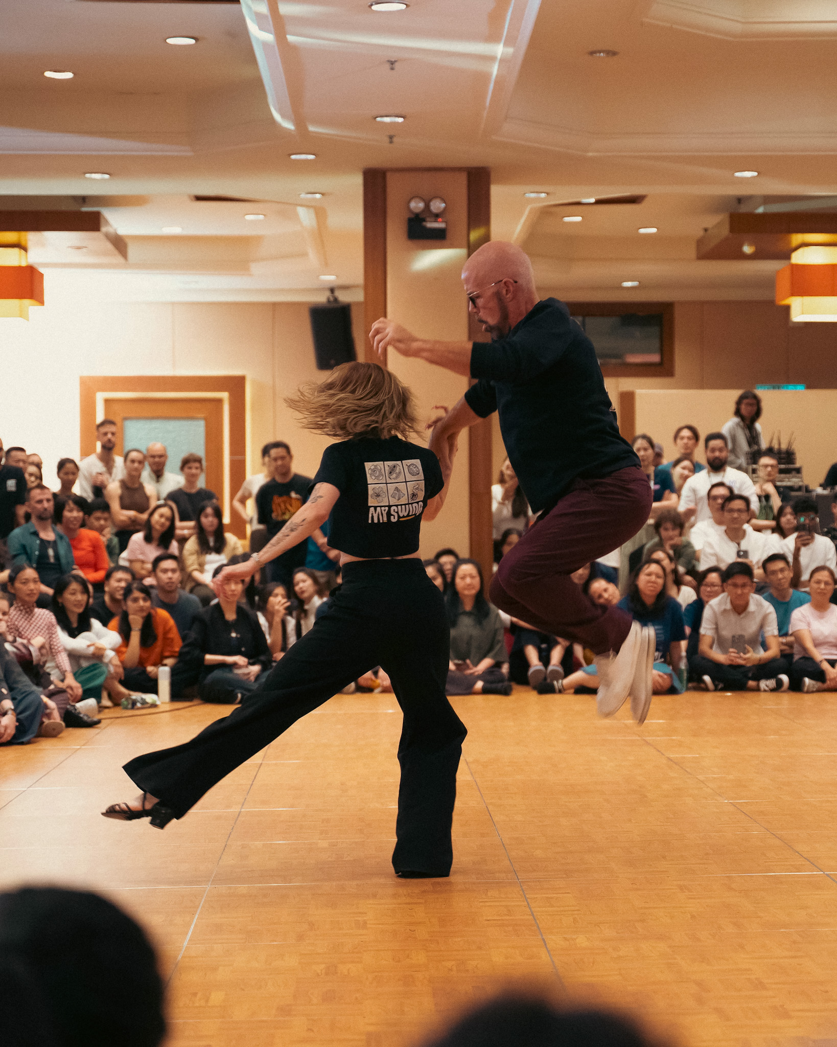 A pair performs a dynamic move for the packed ballroom.