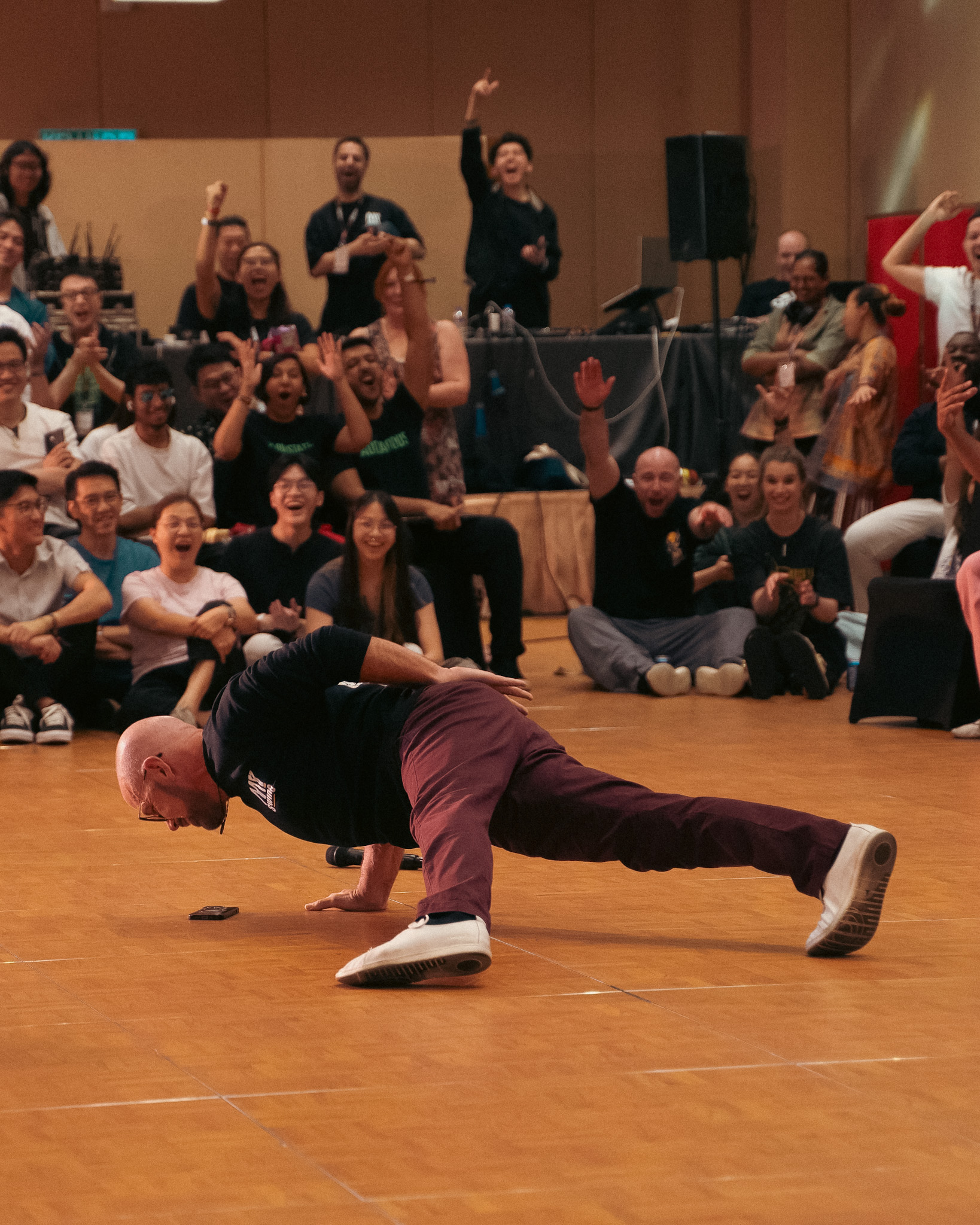 A dancer holds a horizontal pose supported by their partner.