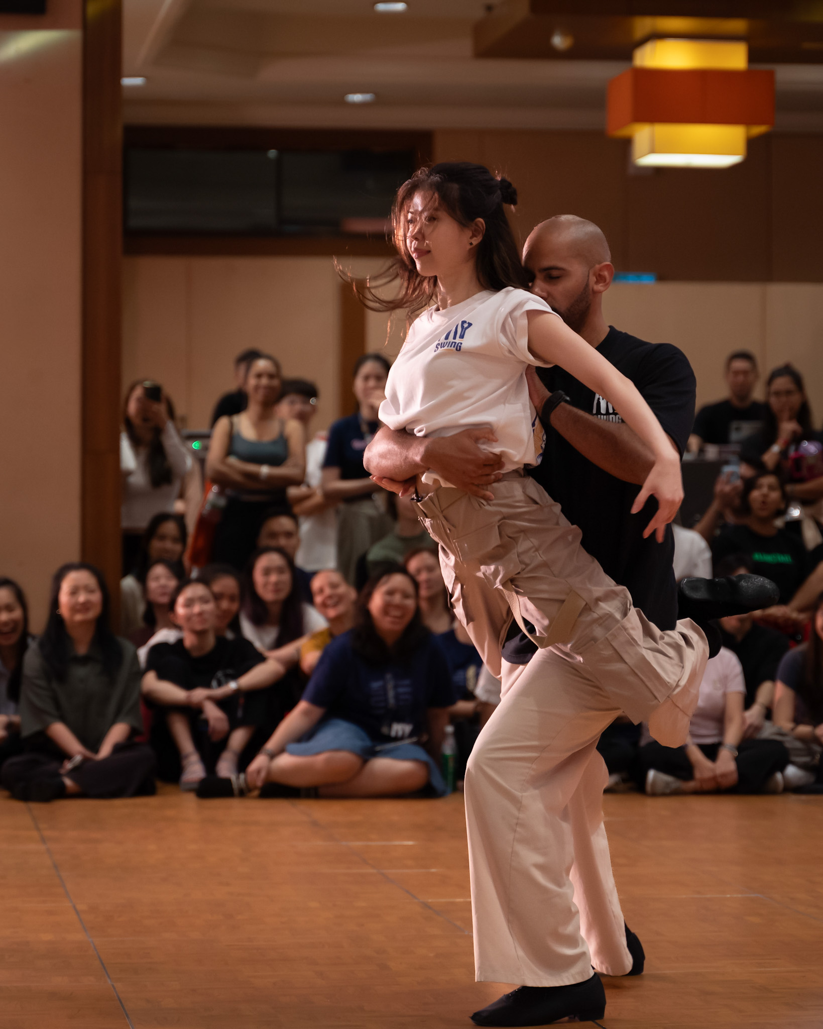A couple holds a balanced lift during a showcase.