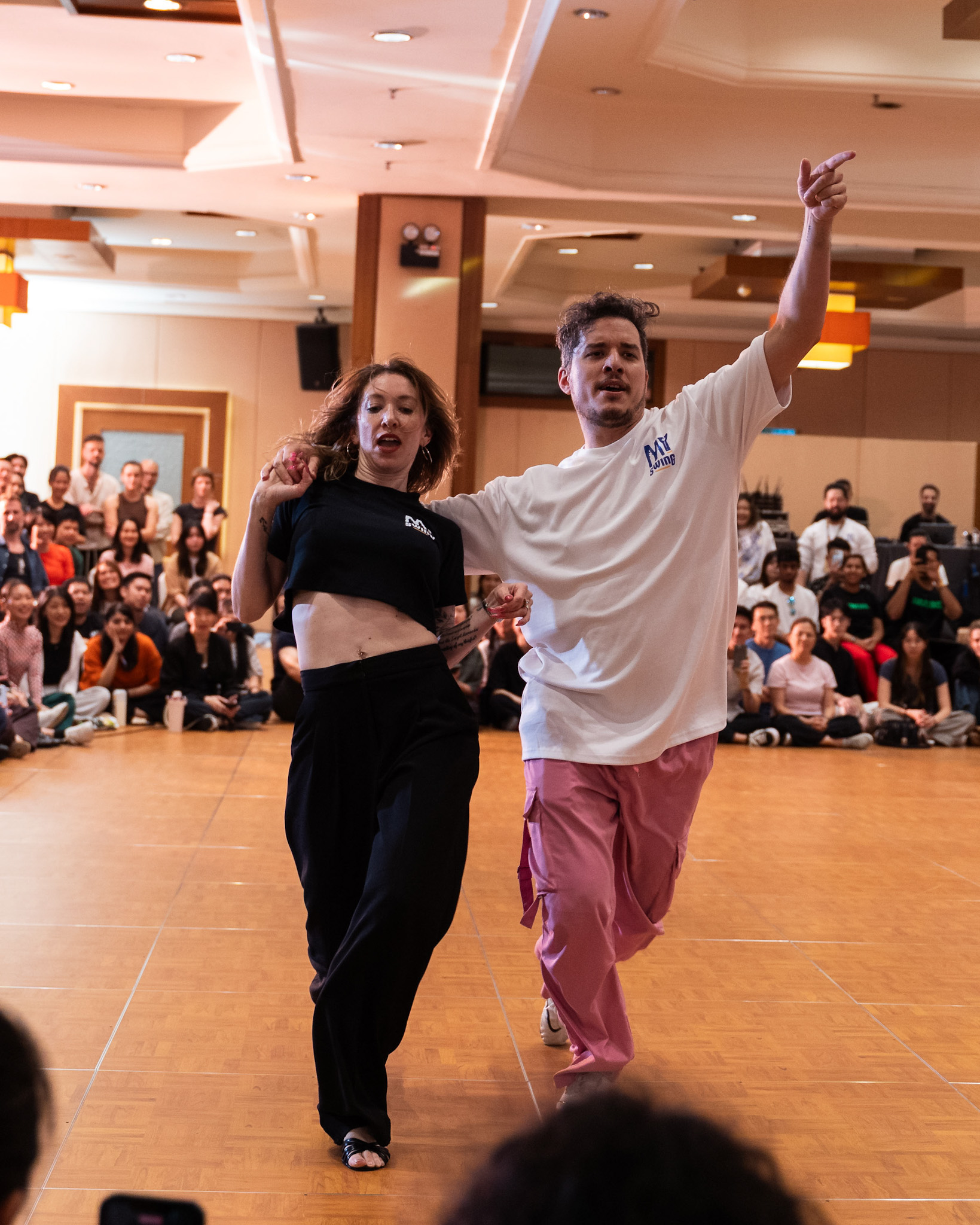 A Pro Invitational pair celebrates with arms raised.