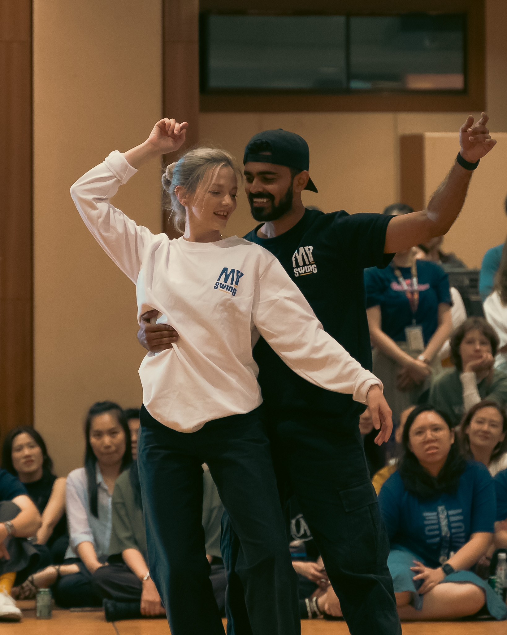 A Pro Invitational couple poses together as the crowd watches.