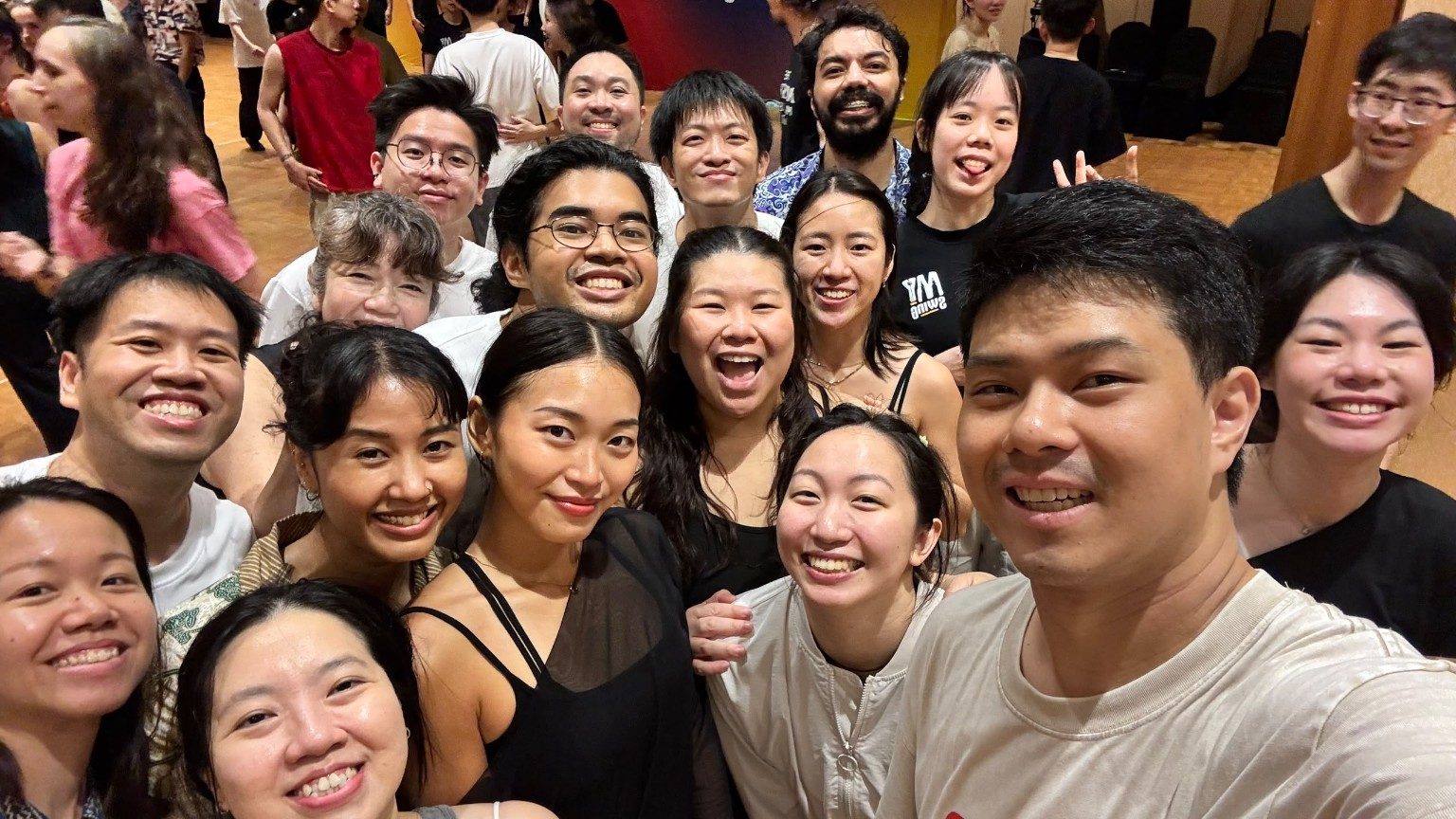 A smiling group gathers for a close selfie on the ballroom floor at MY Swing 2026.