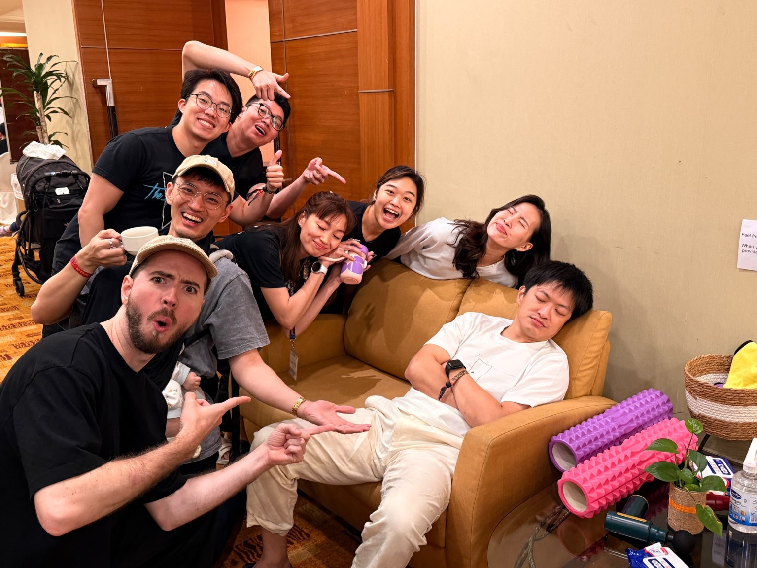 Friends make playful faces around a sofa while one person rests at MY Swing 2026.