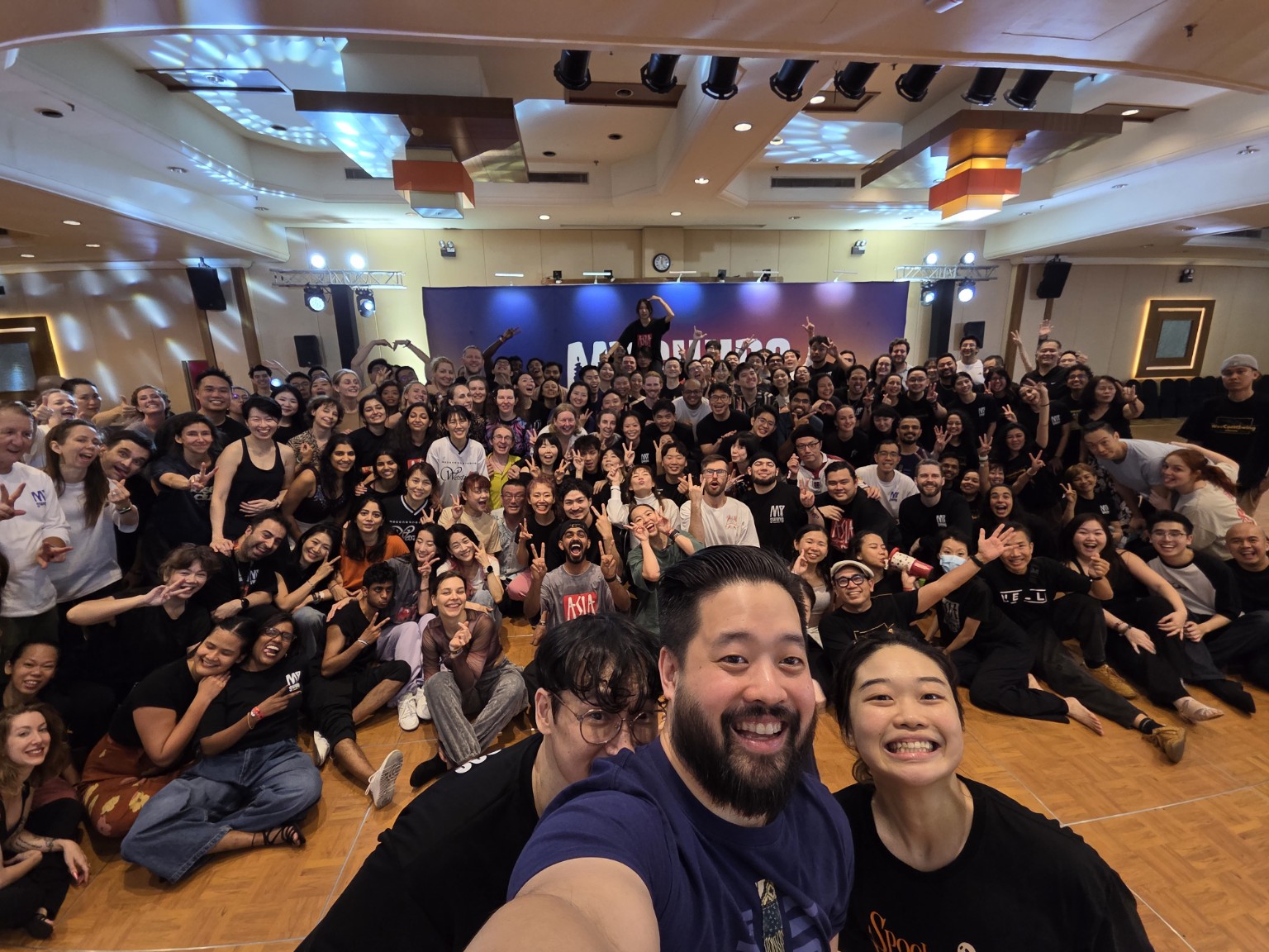 Dancers gather across the ballroom for a group selfie at MY Swing 2026.